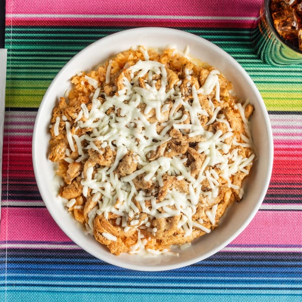 Tacos 4 Ever Burritos & More's chicken and rice dish, topped with melted white cheese.